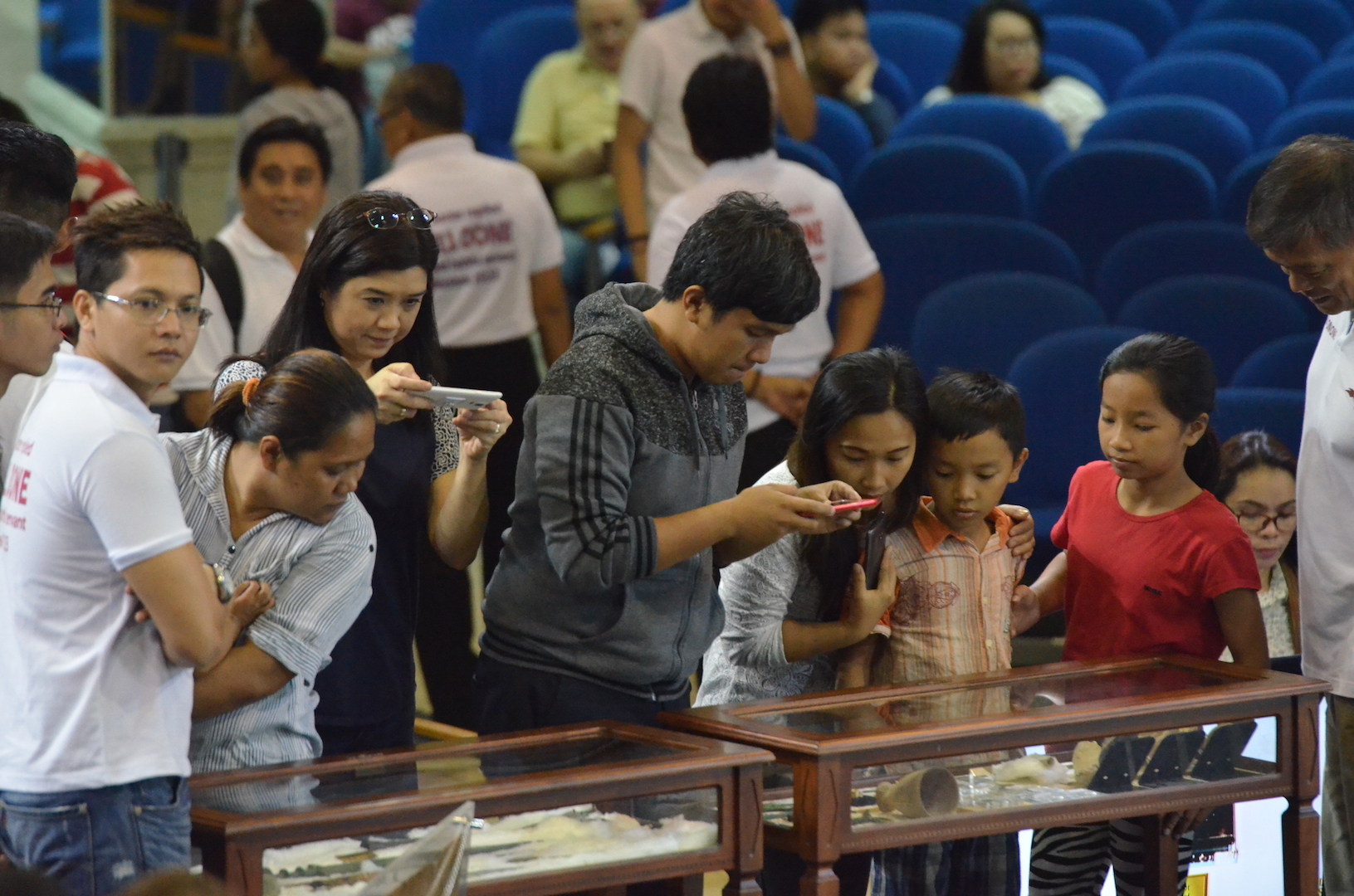 COP members taking pictures of the relics and artifacts in the mini exhibit of the School of the Cross